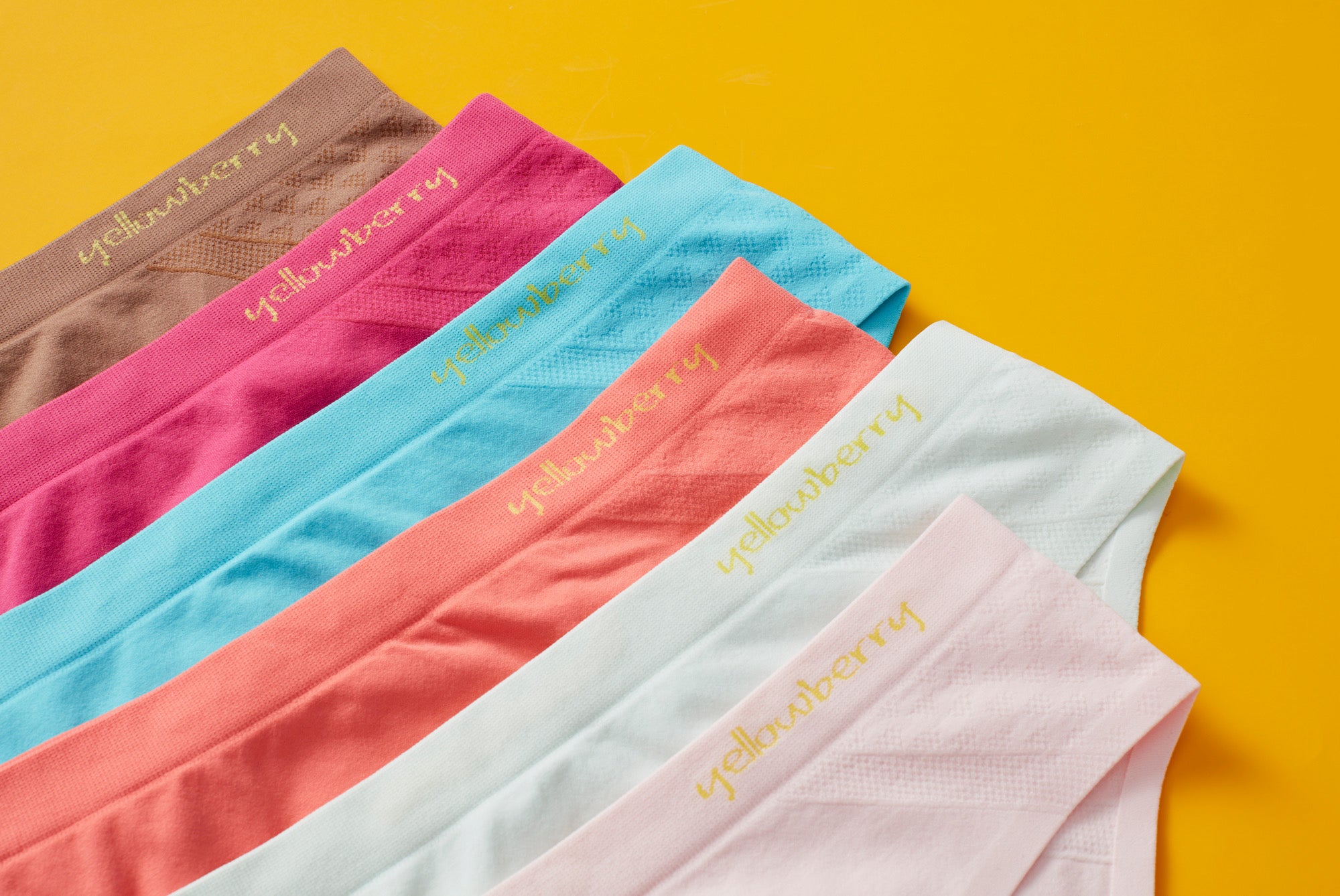 Laydown image of Yellowberry seamless underwear for girls. Basic colors and bright colors in a well-fitting pair of girls undies. Front detail image.