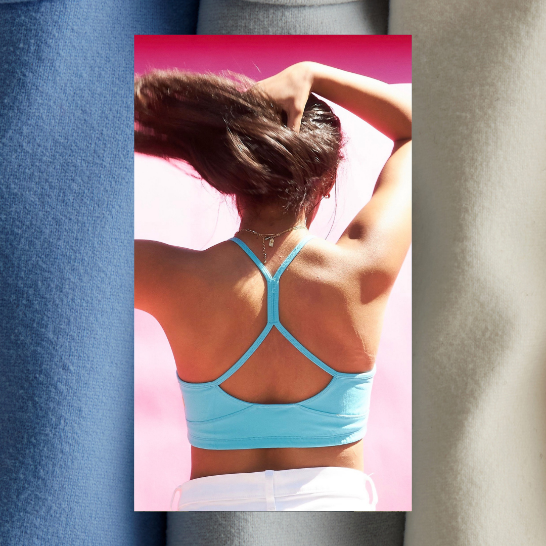 Girl wearing a blue Tink Yellowberry Hybrid Sports Bra. A racerback style, offering full support and coverage. High-impact sports bra with antimicrobial, sweat-wicking fabrics. Double layered, high quality fabric for all day support and comfort.