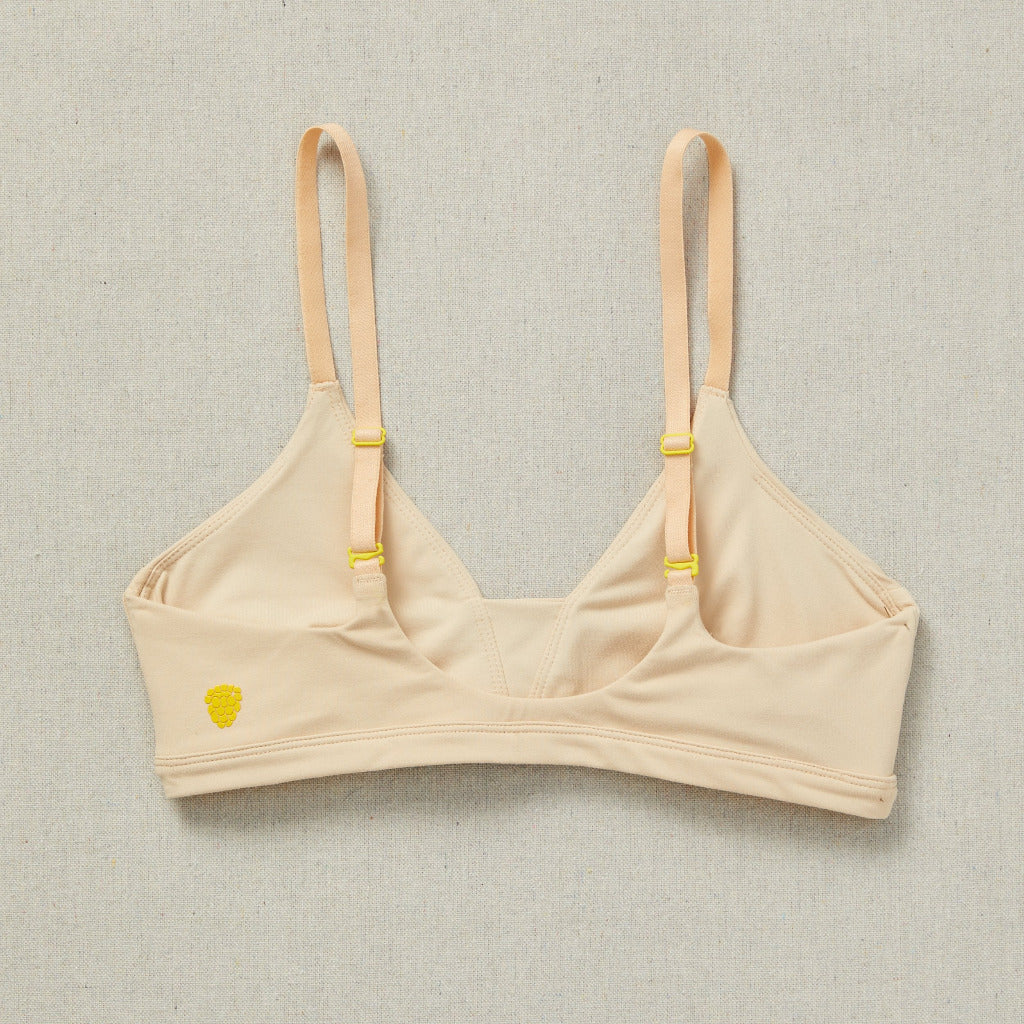 Back close detail image of Yellowberry Wish Bra in beige. The Wish Bra gives supportive definition through shearing and soft space for girls to grow. 