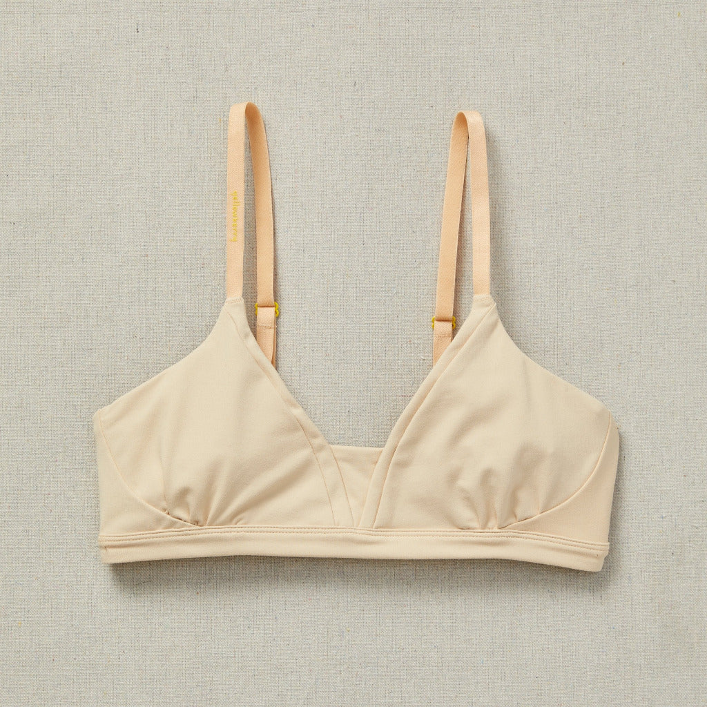 Styled detail image of Yellowberry Wish Bra in beige. The Wish Bra is double-layered and fully lined to ensure full coverage. Softest fabrics, AND made by a female founded company.