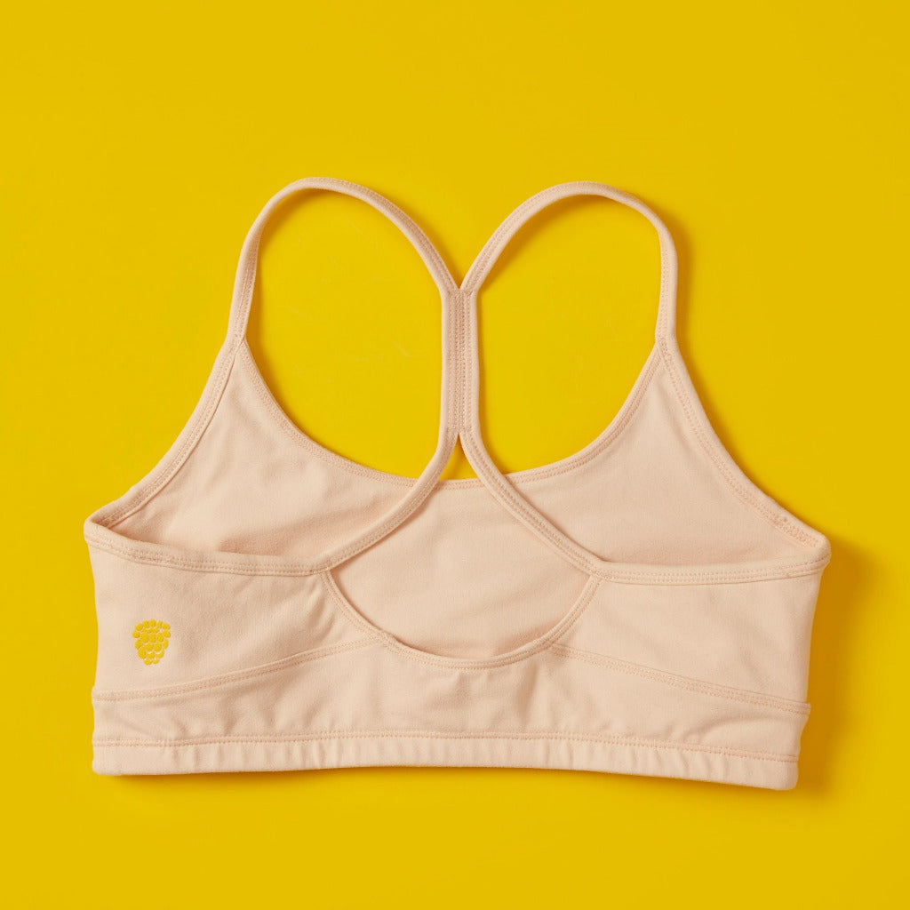 Back close detail image of Yellowberry Tink Hybrid Sports Bra in beige. Like two bras in one! Made with high quality, double-layered, antimicrobial, moisture wicking fabric. Made for all high impact and light activity. Great for dancers!