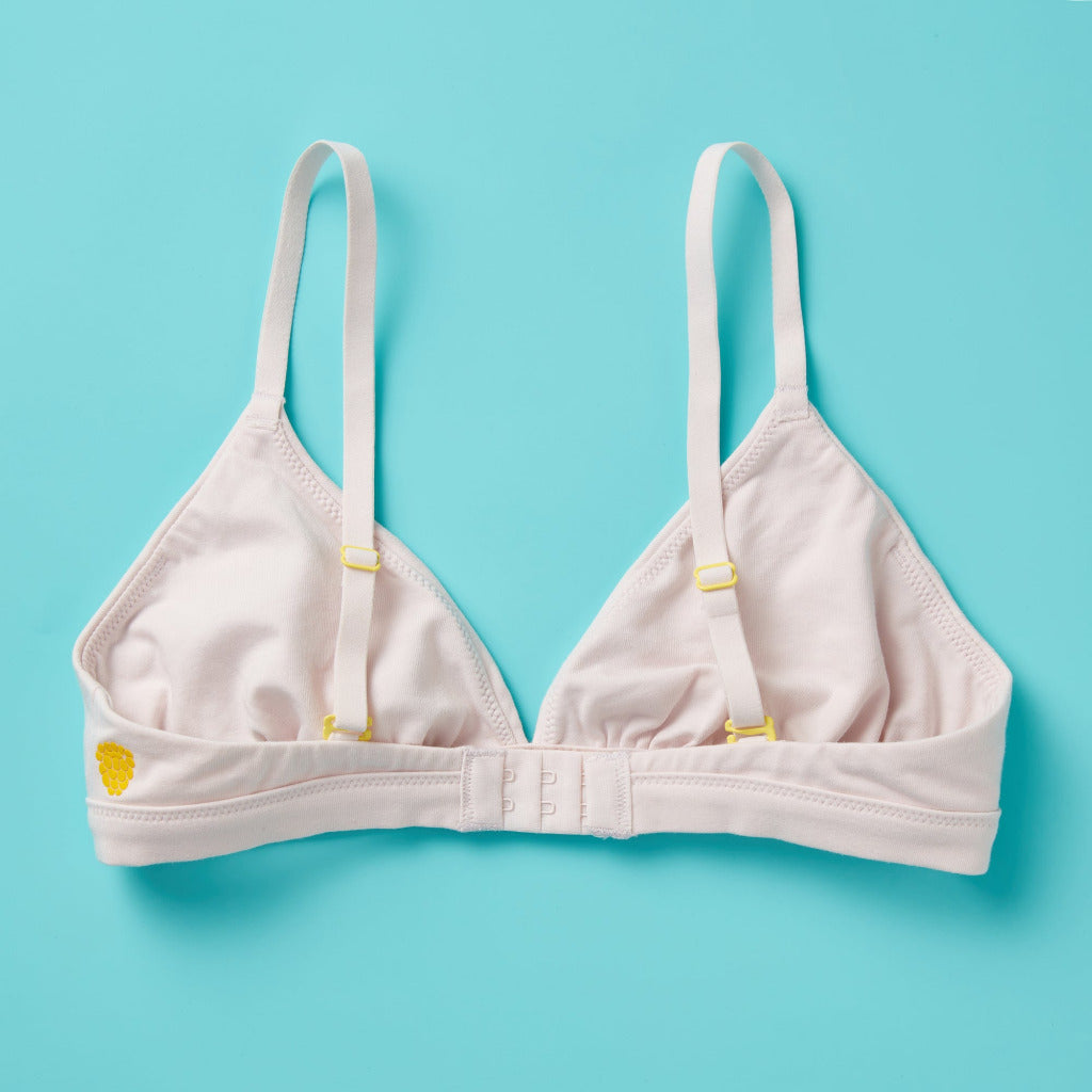 Yellowberry’s Joey Bra for Girls: A bra that grows with you. Made with double layered cotton-spandex fabric (great for sensitive skin!) just for girls beginning to develop. For girls, by girls! Back aydown light pink.