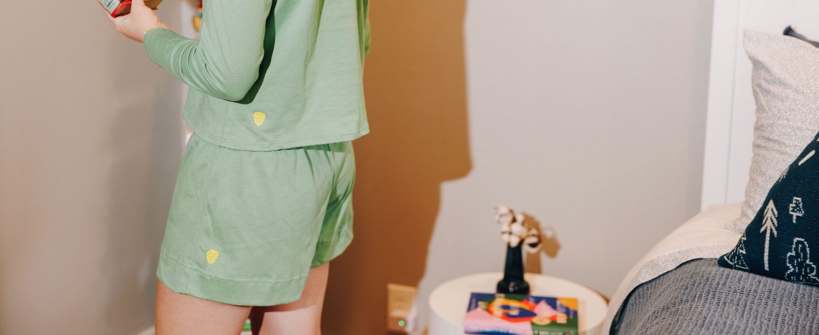 Girl wearing a matching set of a pair of green cotton shorts and a green cotton long sleeve t-shirt