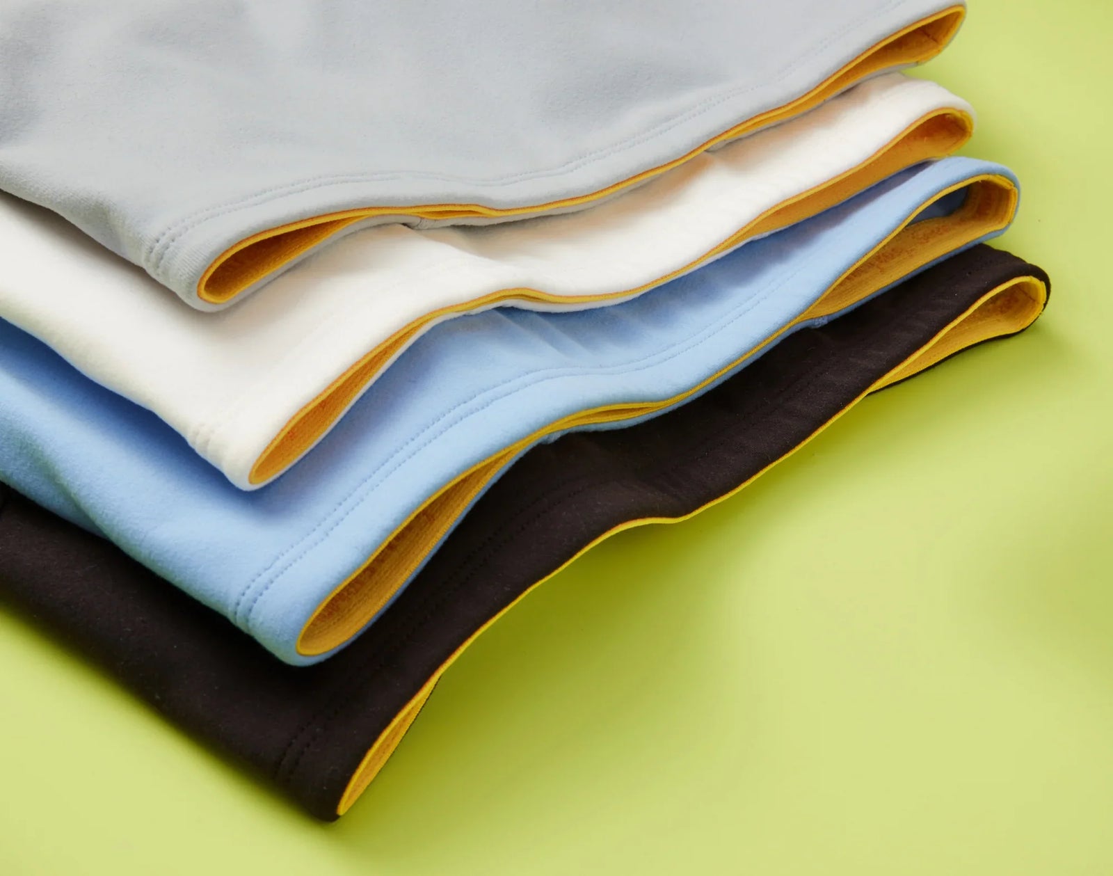 Four Yellowberry bras stacked on top of each other.