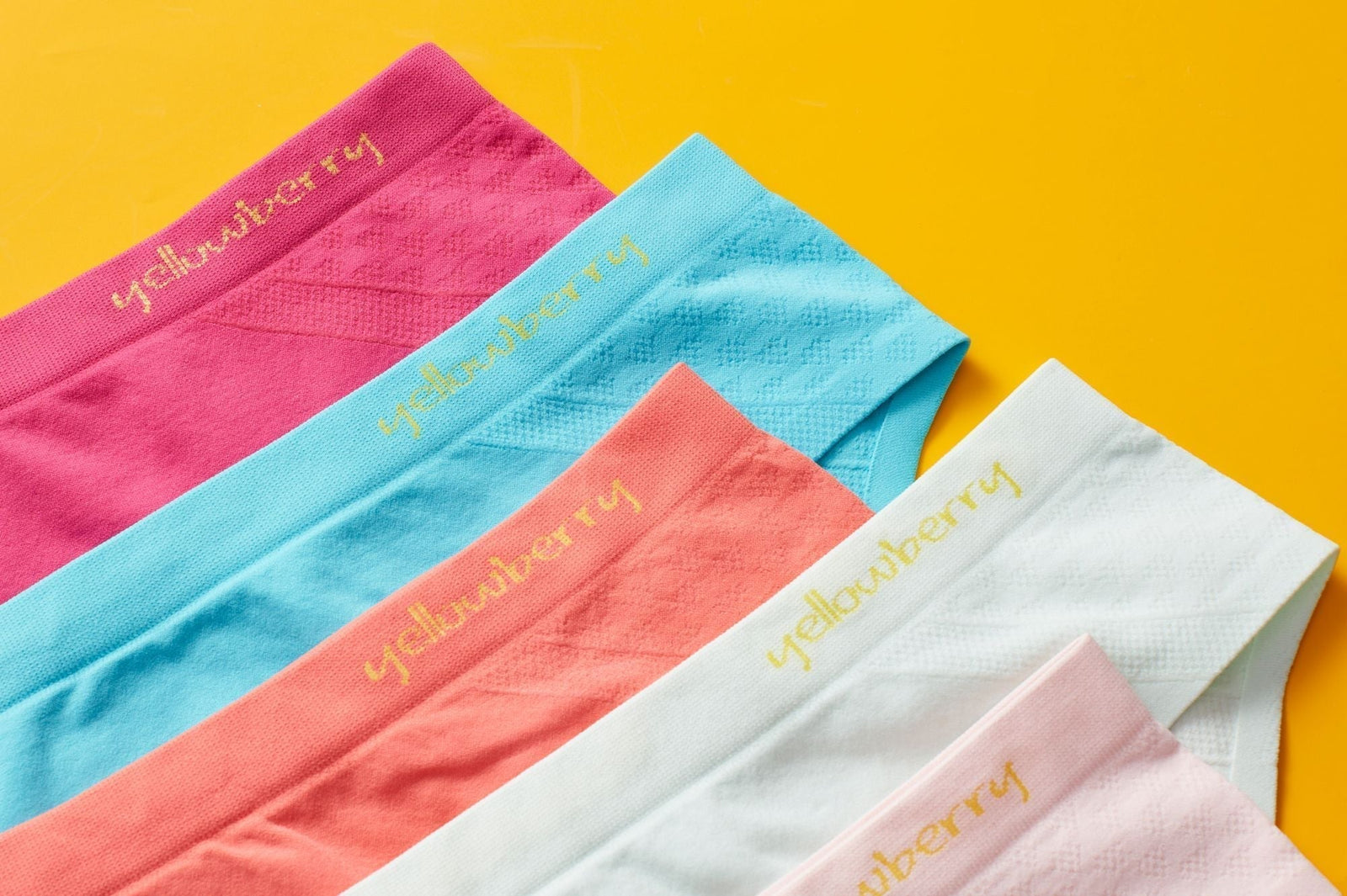 Multiple colors of Yellowberry Seamless Underwear displayed together on a yellow background.