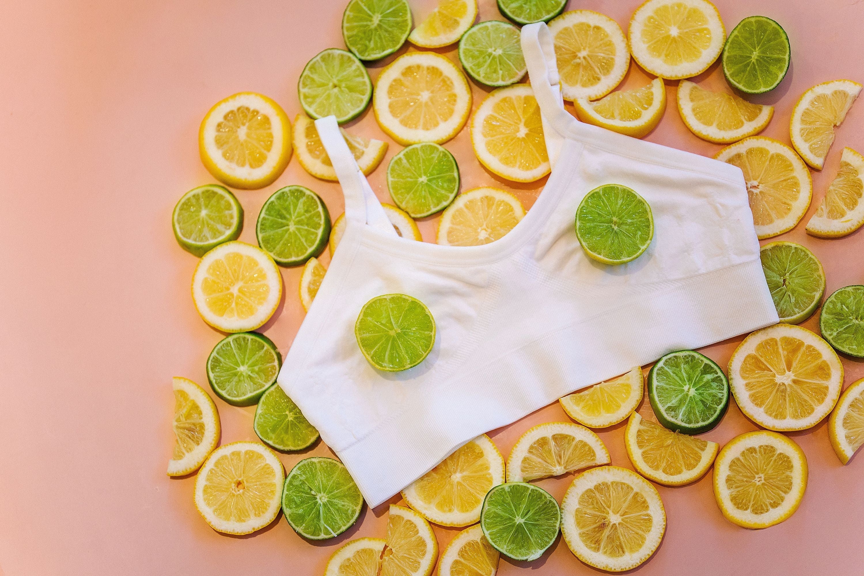 A Yellowberry Seamless Bra in snowflake arranged with fruit on a peach background