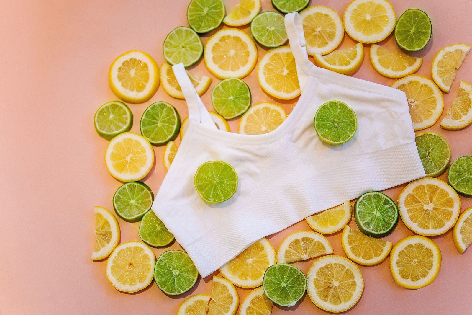 A Yellowberry Seamless Bra in snowflake arranged with fruit on a peach background