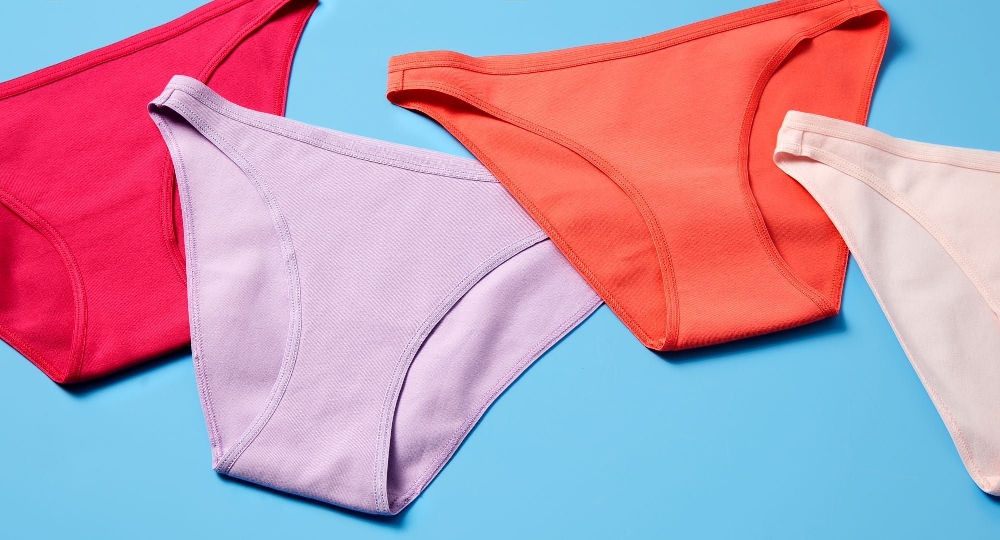 Multiple pairs of Yellowberry underwear in multiple colors on a blue background.