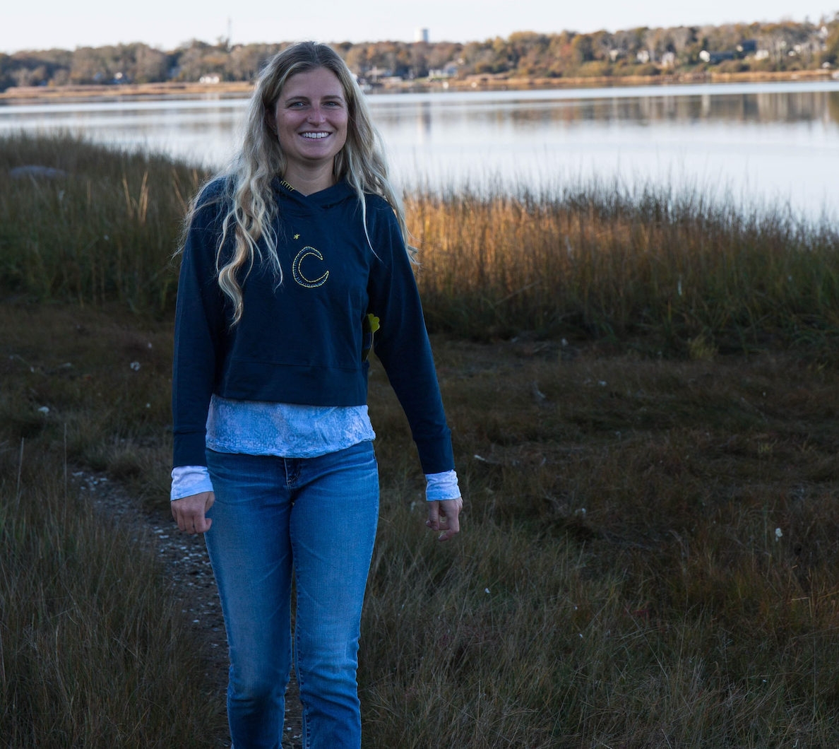 Girl standing in grass wearing a long sleeve t-shirt layered below a cotton girls hoodie
