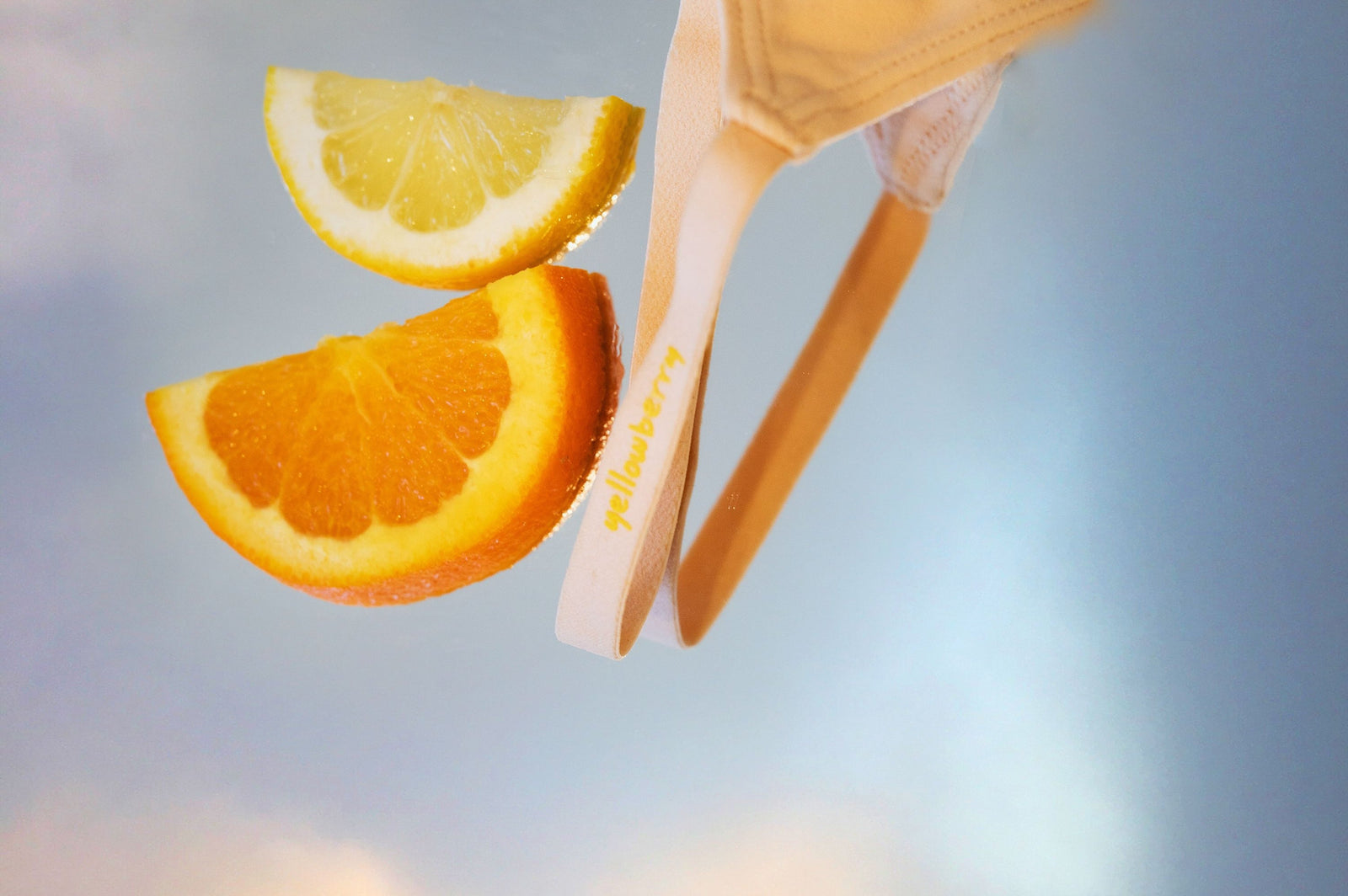 A bra strap styled with fruit slices in an abstract style photo