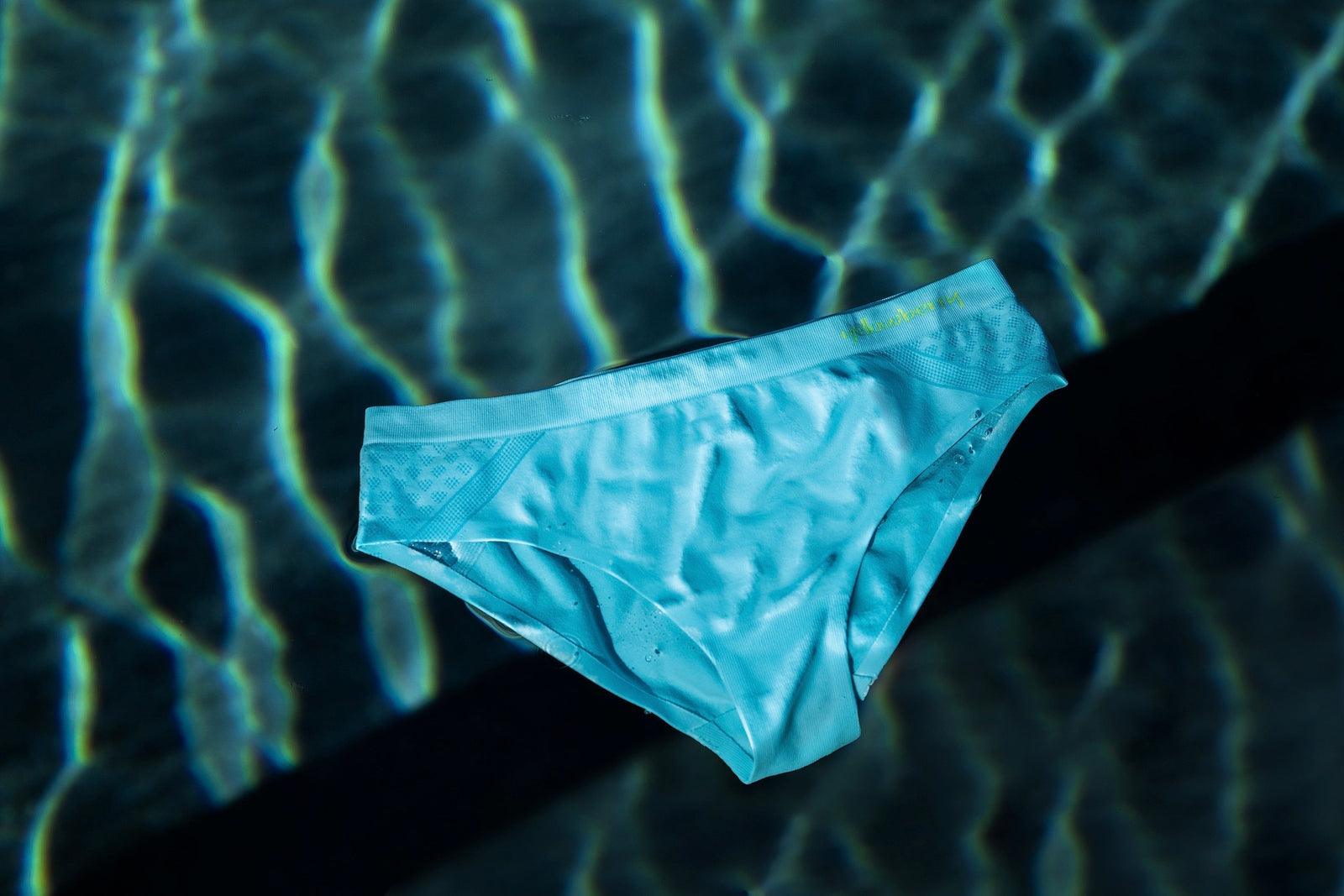 Yellowberry blue seamless underwear floating in water under a bright sun.