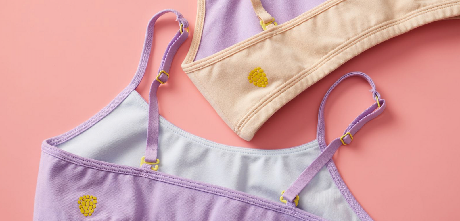 Three Yellowberry Cotton Bras in a back detail image. In color doe (beige) with a light blue interior.