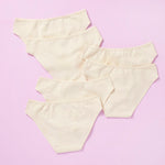 6 pair of beige girls cotton bikini cut underwear on a pretty pink background, back