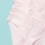 close up image of 6 pair of light pink girls cotton bikini cut underwear assembled on an aqua background, front