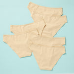 6 pair of girls cotton bikini cut underwear on an aqua background, back