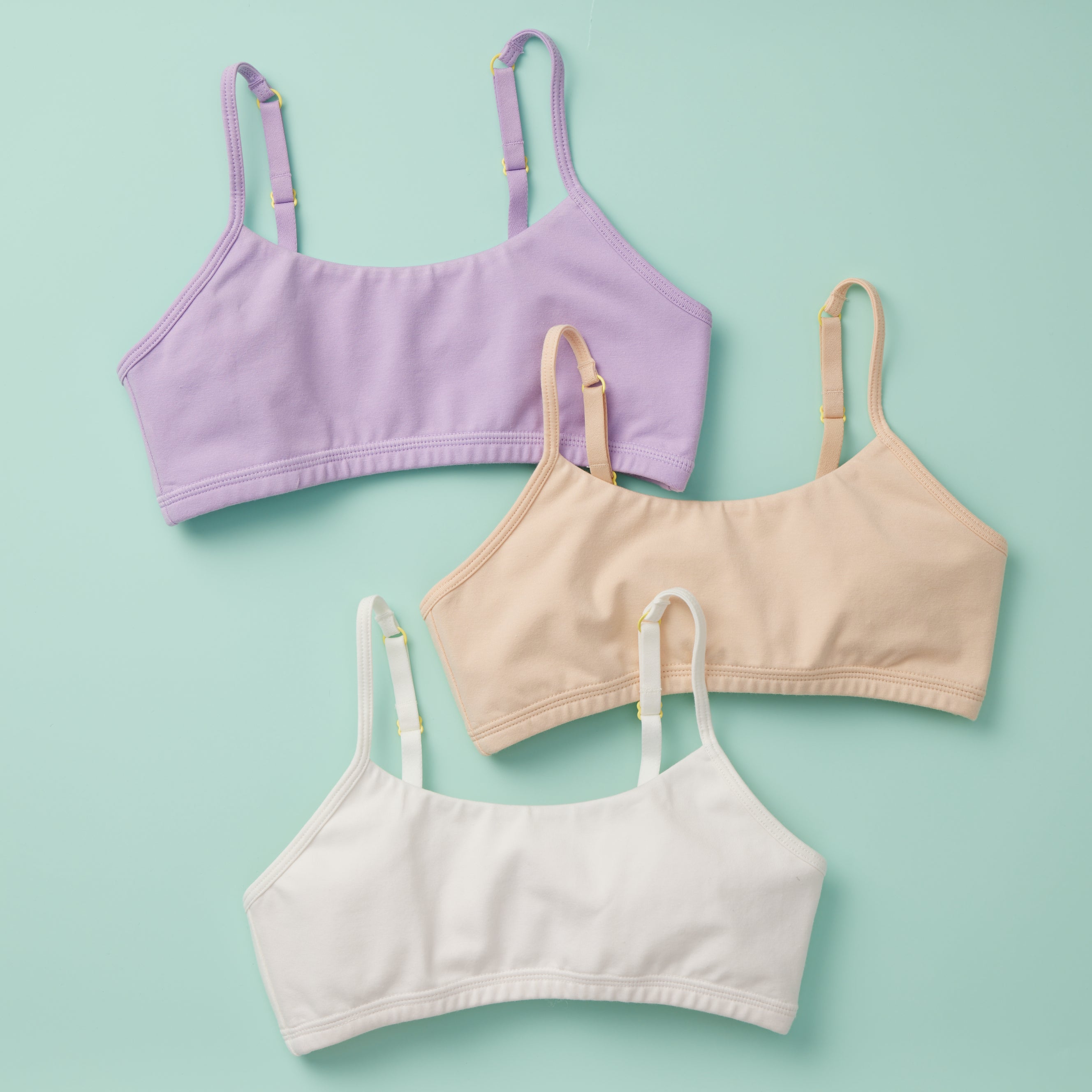 Invisible to the eye best 3PK cotton starter bras for girls shown on green background