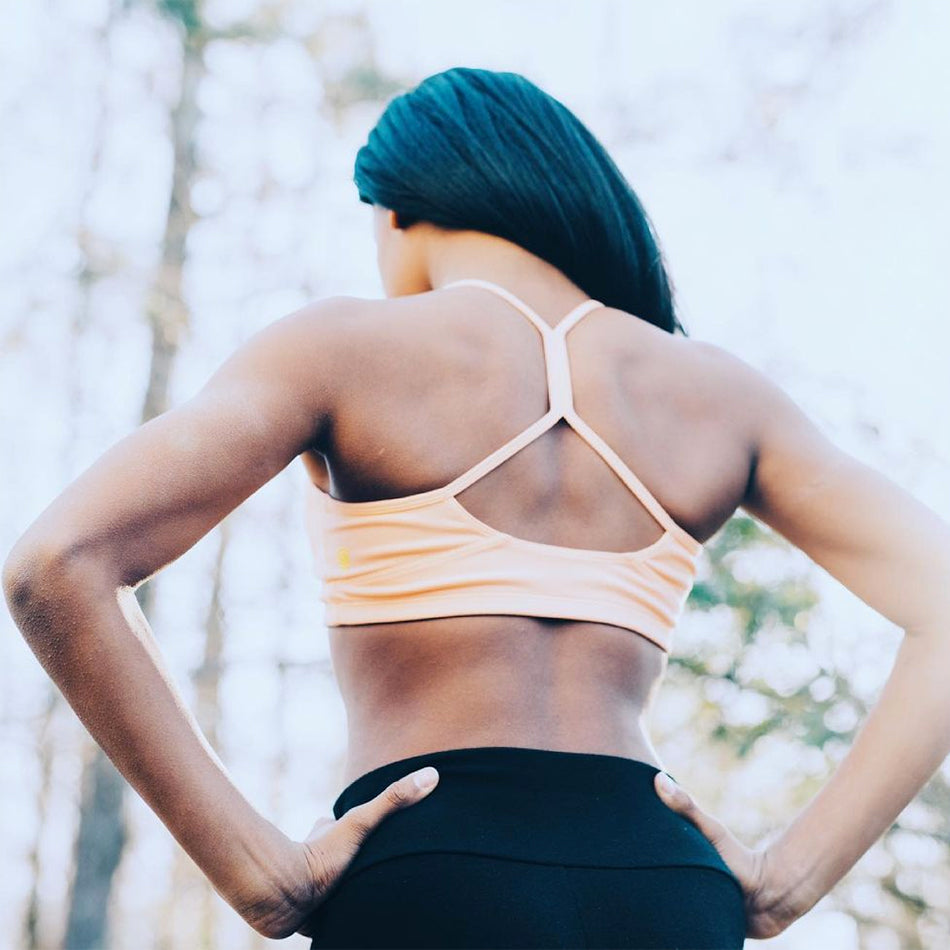 athletic girl's back wearing yellowberry hybrid sports bra