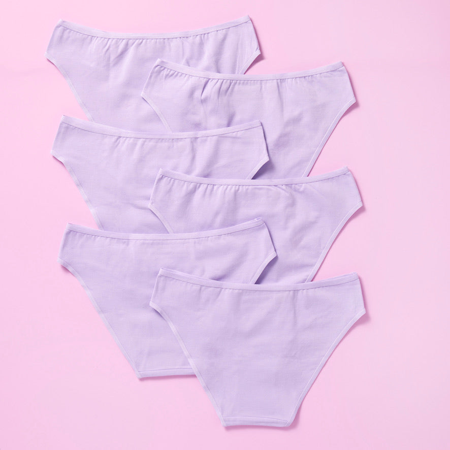 6 pair of light purple girls cotton bikini cut underwear on a pretty pink background, back