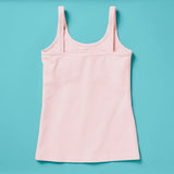 Laydown image of a light pink girls cotton tank top with a shelf bra on an aqua background, back
