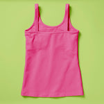 Laydown image of a hot pink girls cotton tank top with a shelf bra on a soft green background, back