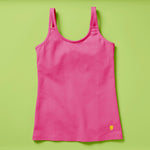 Laydown image of a hot pink girls cotton tank top with a shelf bra on a soft green background, front