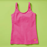 Laydown image of a hot pink girls cotton tank top with a shelf bra on a soft green background, front