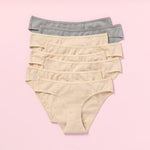 Eight pairs of women's underwear in beige and gray on a pink background