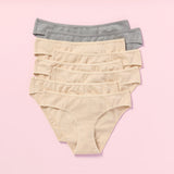 Eight pairs of women's underwear in beige and gray on a pink background