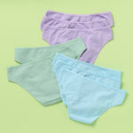 The back of eight pairs of women's underwear in purple, green, and blue on a light green background 