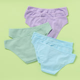 The back of eight pairs of women's underwear in purple, green, and blue on a light green background 