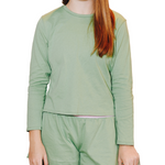 Front view of green long sleeve whisper tshirt on a girl with matching green cotton bliss shorts