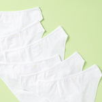 close up 6 pair of girls cotton bikini underwear assembled on a light green background, back
