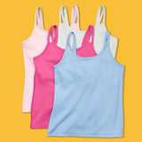 Laydown image of a group of four cotton camisoles with a shelf bra on a bright yellow orange background