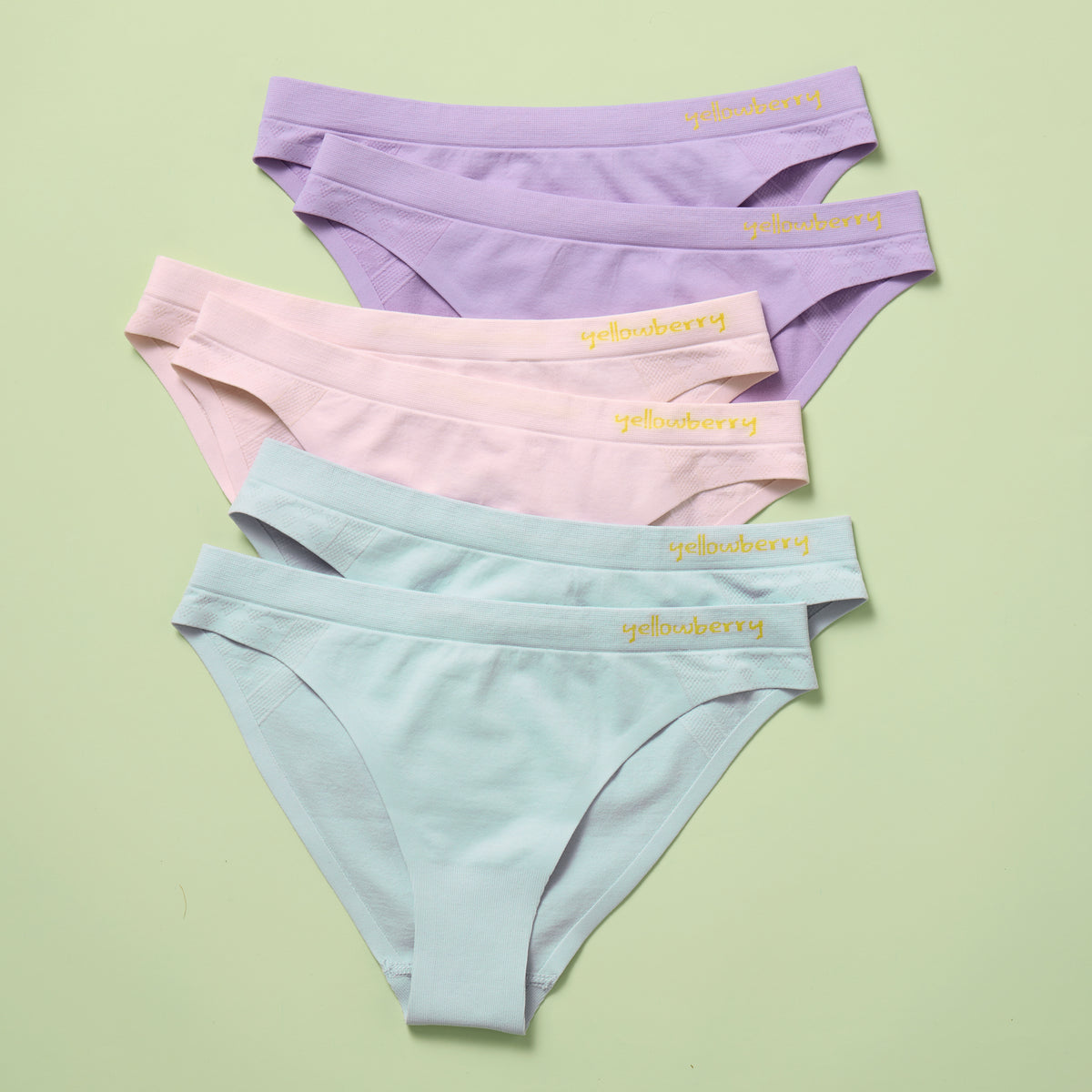 Six pairs of pastel-colored underwear with a brand name on a light green background