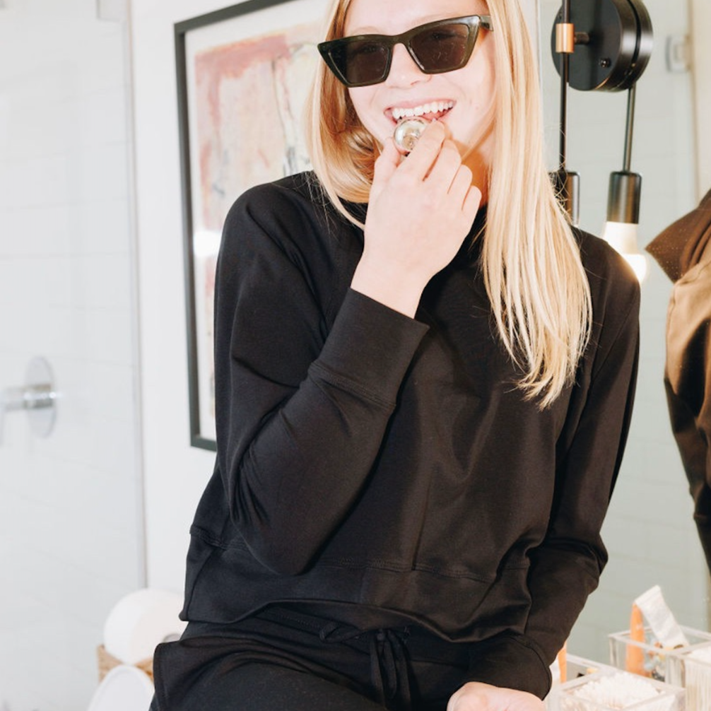 Yellowberry Downtown Hoodie in soft cotton, and effortless Style. Designed with a cross-front hood for subtle flair, it falls just below the navel, hitting the hip for a relaxed, effortless fit. Each piece in our lounge collection embodies chic, timeless style, all essentials you'll reach for all cozy season long. Made with pride in the USA, in colors thoughtfully chosen to mix and match seamlessly. We hope you enjoy them as much as we loved creating them for you. Starry Night with lip gloss