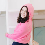 Yellowberry Downtown Hoodie in soft cotton, and effortless Style. Designed with a cross-front hood for subtle flair, it falls just below the navel, hitting the hip for a relaxed, effortless fit. Each piece in our lounge collection embodies chic, timeless style, all essentials you'll reach for all cozy season long. Made with pride in the USA, in colors thoughtfully chosen to mix and match seamlessly. We hope you enjoy them as much as we loved creating them for you. Hot Pink side
