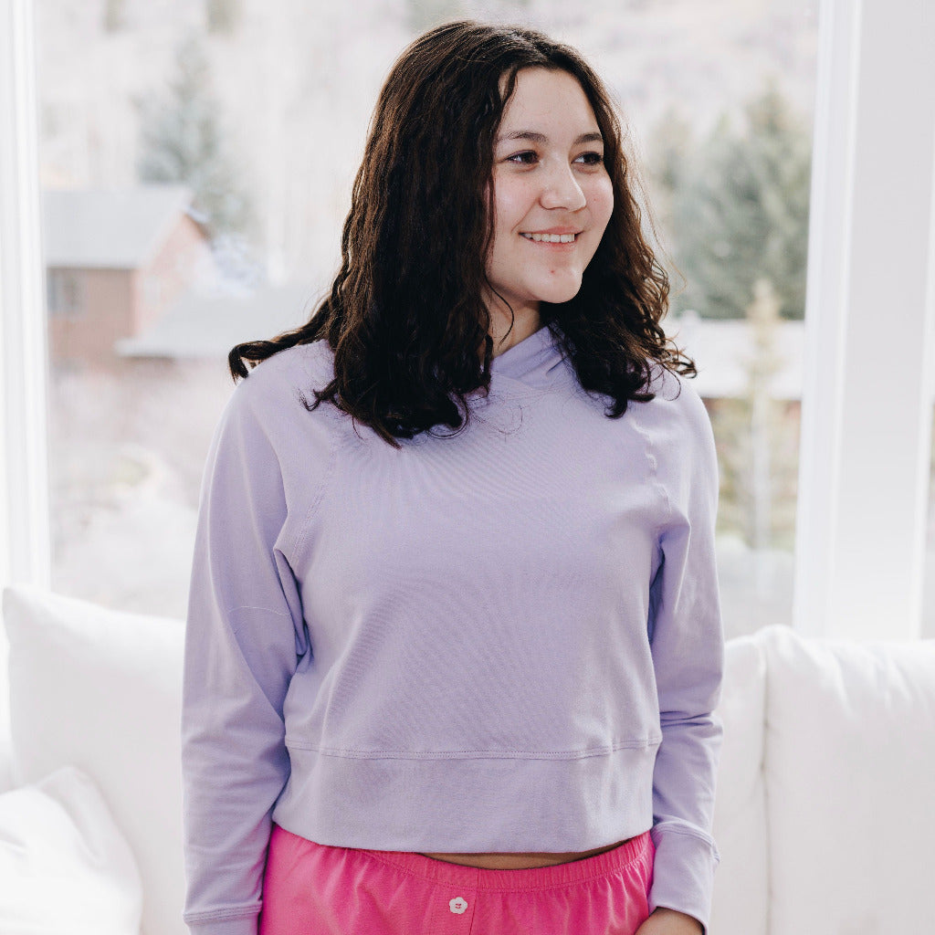 Yellowberry Downtown Hoodie in soft cotton, and effortless Style. Designed with a cross-front hood for subtle flair, it falls just below the navel, hitting the hip for a relaxed, effortless fit. Each piece in our lounge collection embodies chic, timeless style, all essentials you'll reach for all cozy season long. Made with pride in the USA, in colors thoughtfully chosen to mix and match seamlessly. We hope you enjoy them as much as we loved creating them for you. Huckleberry front on model in window