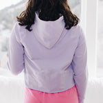 Yellowberry Downtown Hoodie in soft cotton, and effortless Style. Designed with a cross-front hood for subtle flair, it falls just below the navel, hitting the hip for a relaxed, effortless fit. Each piece in our lounge collection embodies chic, timeless style, all essentials you'll reach for all cozy season long. Made with pride in the USA, in colors thoughtfully chosen to mix and match seamlessly. We hope you enjoy them as much as we loved creating them for you. Huckleberry back on model in window