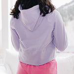 Yellowberry Downtown Hoodie in soft cotton, and effortless Style. Designed with a cross-front hood for subtle flair, it falls just below the navel, hitting the hip for a relaxed, effortless fit. Each piece in our lounge collection embodies chic, timeless style, all essentials you'll reach for all cozy season long. Made with pride in the USA, in colors thoughtfully chosen to mix and match seamlessly. We hope you enjoy them as much as we loved creating them for you. Huckleberry back with hot pink Bliss Short.