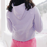 Yellowberry Downtown Hoodie in soft cotton, and effortless Style. Designed with a cross-front hood for subtle flair, it falls just below the navel, hitting the hip for a relaxed, effortless fit. Each piece in our lounge collection embodies chic, timeless style, all essentials you'll reach for all cozy season long. Made with pride in the USA, in colors thoughtfully chosen to mix and match seamlessly. We hope you enjoy them as much as we loved creating them for you. Huckleberry back with hot pink Bliss Short.