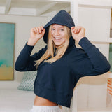 Yellowberry Downtown Hoodie in soft cotton, and effortless Style. Designed with a cross-front hood for subtle flair, it falls just below the navel, hitting the hip for a relaxed, effortless fit. Each piece in our lounge collection embodies chic, timeless style, all essentials you'll reach for all cozy season long. Made with pride in the USA, in colors thoughtfully chosen to mix and match seamlessly. We hope you enjoy them as much as we loved creating them for you. Moonbeam Navy front on model hood on
