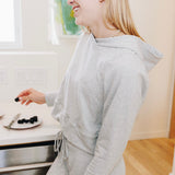Yellowberry Downtown Hoodie in soft cotton, and effortless Style. Designed with a cross-front hood for subtle flair, it falls just below the navel, hitting the hip for a relaxed, effortless fit. Each piece in our lounge collection embodies chic, timeless style, all essentials you'll reach for all cozy season long. Made with pride in the USA, in colors thoughtfully chosen to mix and match seamlessly. We hope you enjoy them as much as we loved creating them for you. Morning Mist side view on model