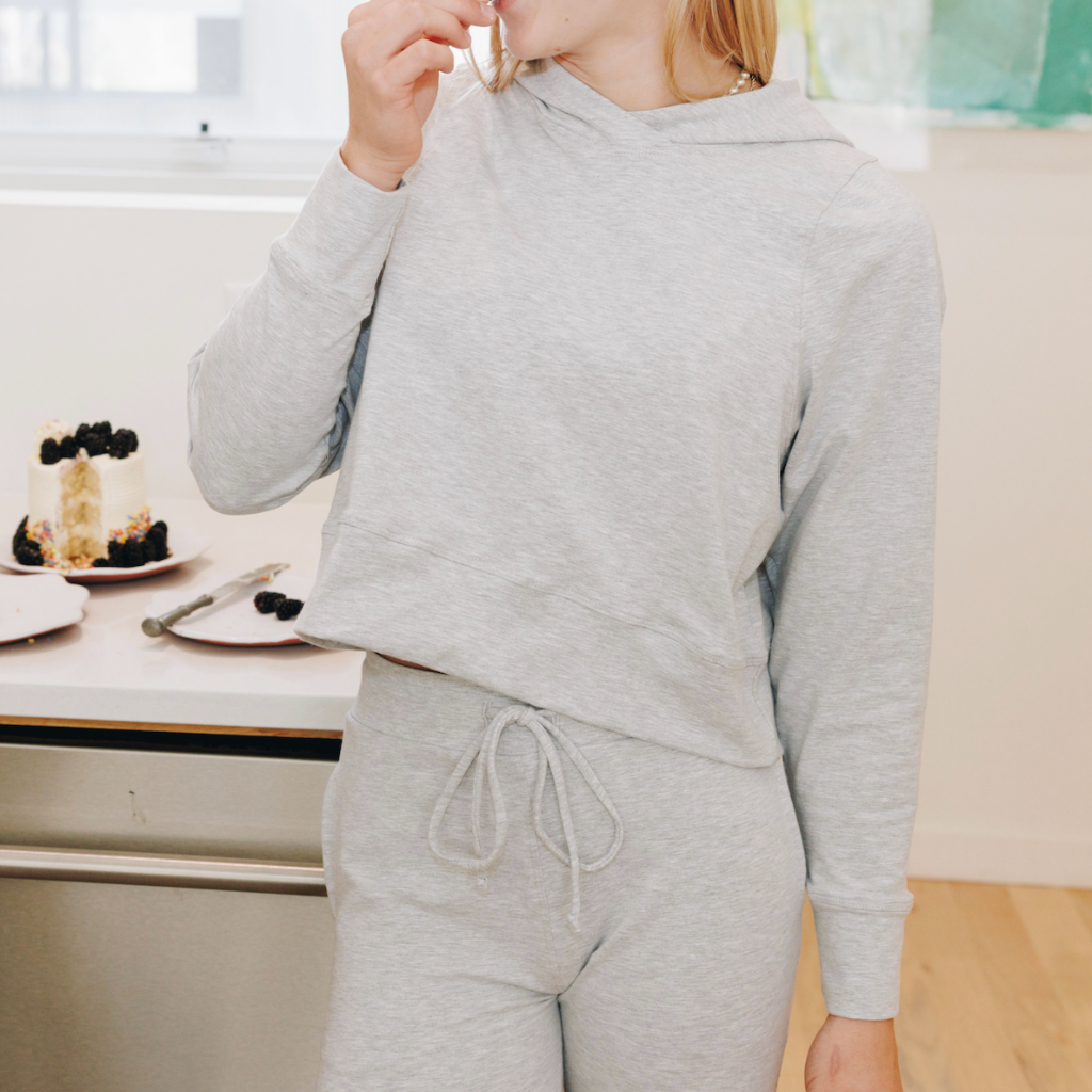 Yellowberry Downtown Hoodie in soft cotton, and effortless Style. Designed with a cross-front hood for subtle flair, it falls just below the navel, hitting the hip for a relaxed, effortless fit. Each piece in our lounge collection embodies chic, timeless style, all essentials you'll reach for all cozy season long. Made with pride in the USA, in colors thoughtfully chosen to mix and match seamlessly. We hope you enjoy them as much as we loved creating them for you. Morning Mist front on model