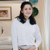 Yellowberry Downtown Hoodie in soft cotton, and effortless Style. Designed with a cross-front hood for subtle flair, it falls just below the navel, hitting the hip for a relaxed, effortless fit. Each piece in our lounge collection embodies chic, timeless style, all essentials you'll reach for all cozy season long. Made with pride in the USA, in colors thoughtfully chosen to mix and match seamlessly. We hope you enjoy them as much as we loved creating them for you. Snowflake front