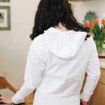 Yellowberry Downtown Hoodie in soft cotton, and effortless Style. Designed with a cross-front hood for subtle flair, it falls just below the navel, hitting the hip for a relaxed, effortless fit. Each piece in our lounge collection embodies chic, timeless style, all essentials you'll reach for all cozy season long. Made with pride in the USA, in colors thoughtfully chosen to mix and match seamlessly. We hope you enjoy them as much as we loved creating them for you. Snowflake back