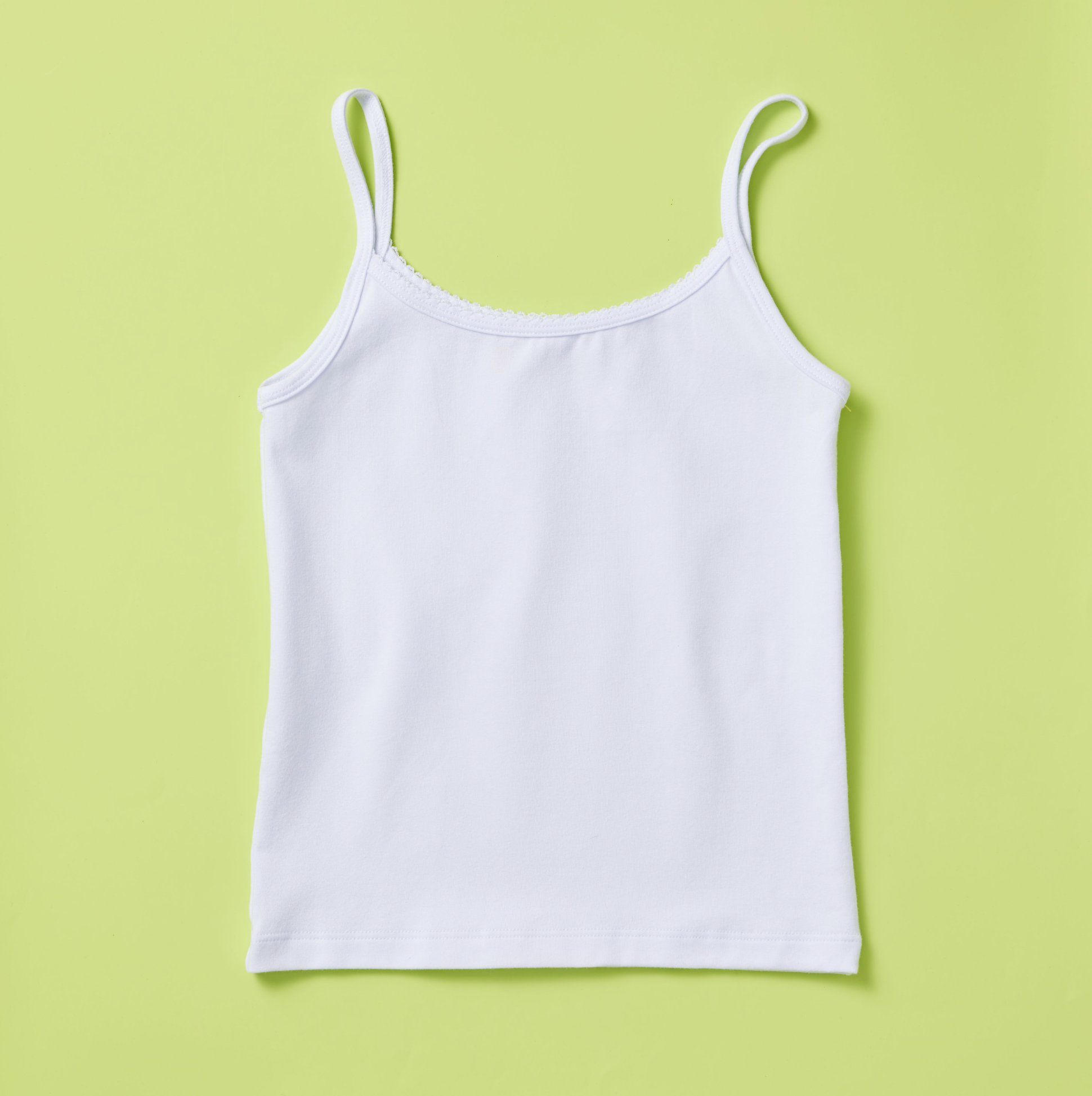 Yellowberry Girls Jane Classic Everyday Cotton Camisole Tank Top. This super soft, single-layer cami features a lovely scoop neck with a delicate finish detail and a fully hemmed bottom. Made with high-quality, luscious fabric that offers a great fit, wonderful coverage and lots of support. It's also a fantastic option for sensitive skin! This beloved piece is both delicately simple and beautifully made in the USA. White front on lime