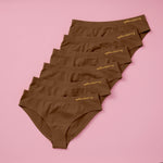 Best-Selling Twistr Girls Seamless Bikini cut underwear by Yellowberry. Front image of Mocha (brown) bundle on pink background. 