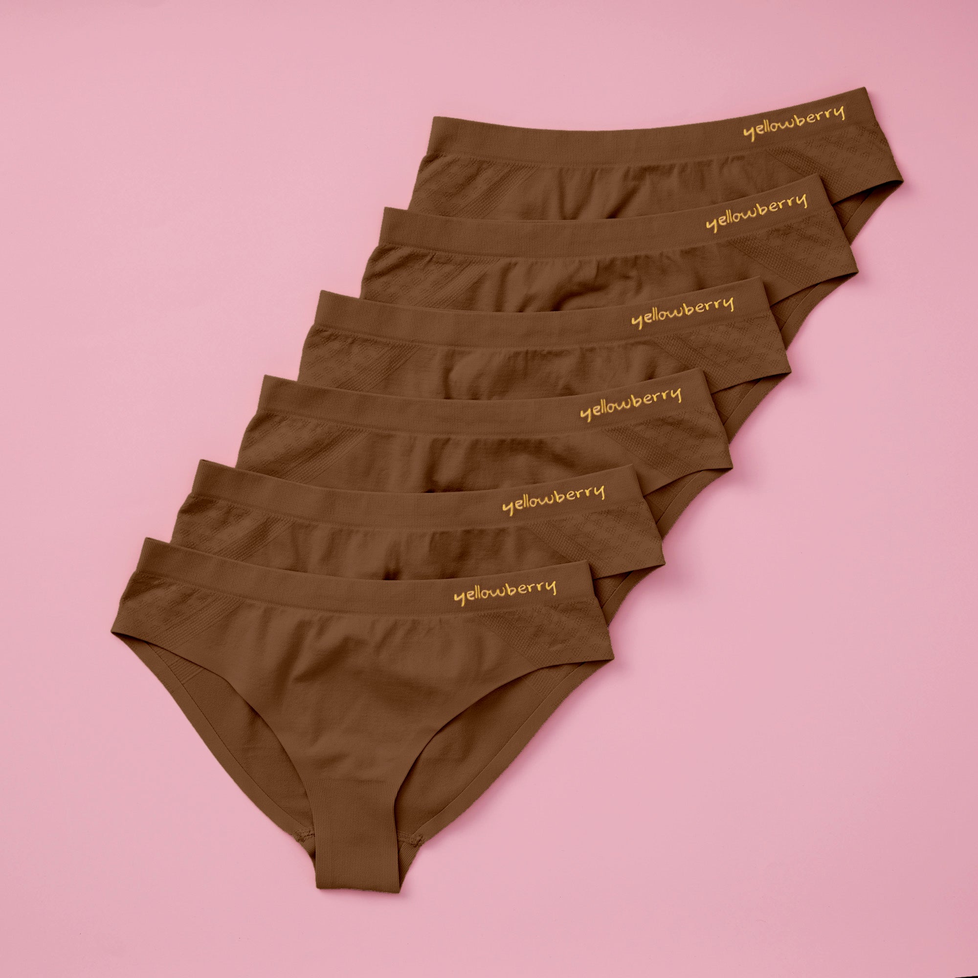Best-Selling Twistr Girls Seamless Bikini cut underwear by Yellowberry. Front image of Mocha (brown) bundle on pink background. 