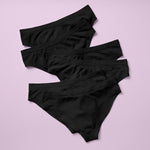 Best-Selling Twistr Girls Seamless Bikini cut underwear by Yellowberry. Back image of Starry Night (black) bundle on pink background. 