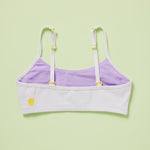 White and lavender bra with yellow accents on a light green background